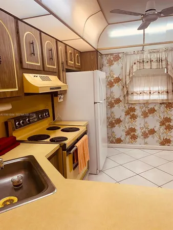 a kitchen that has a sink and a stove