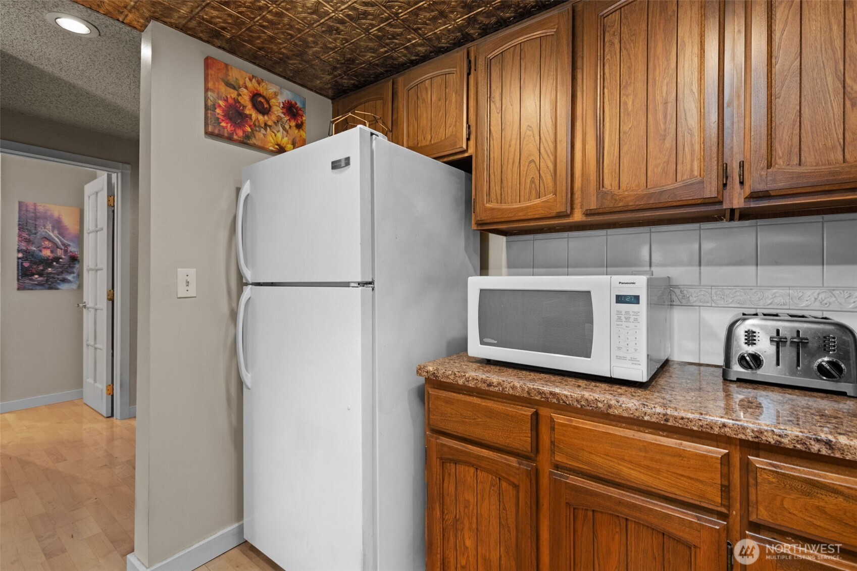 2517 Northeast 4th Street, Unit 523 Renton, WA 98056 - Photo 11 of 32 a white refrigerator freezer sitting in a kitchen