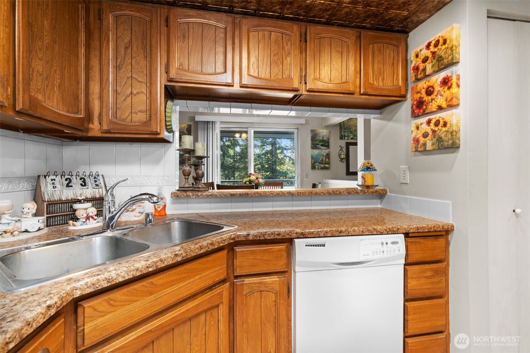 2517 Northeast 4th Street, Unit 523 Renton, WA 98056 - Photo 12 of 32 a kitchen with granite countertop stainless steel appliances a sink and cabinets