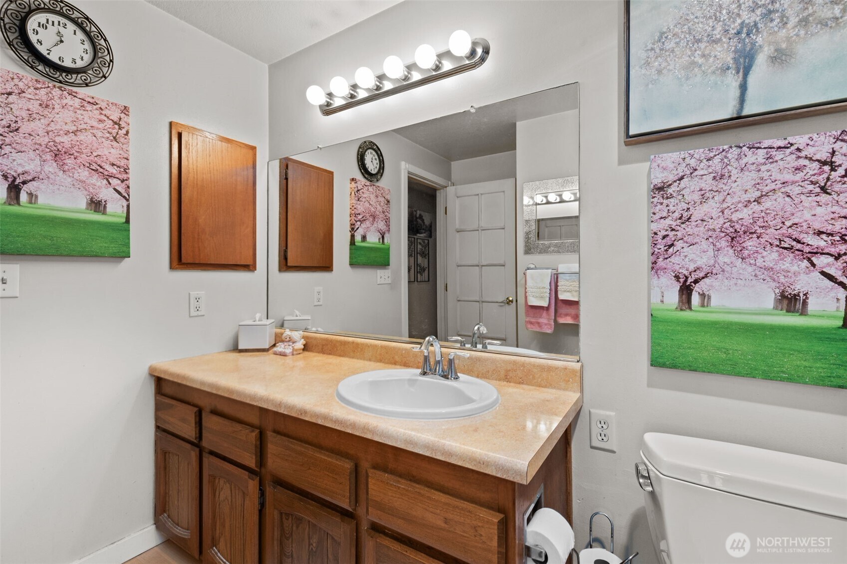 2517 Northeast 4th Street, Unit 523 Renton, WA 98056 - Photo 25 of 32 a bathroom with a sink a toilet and mirror