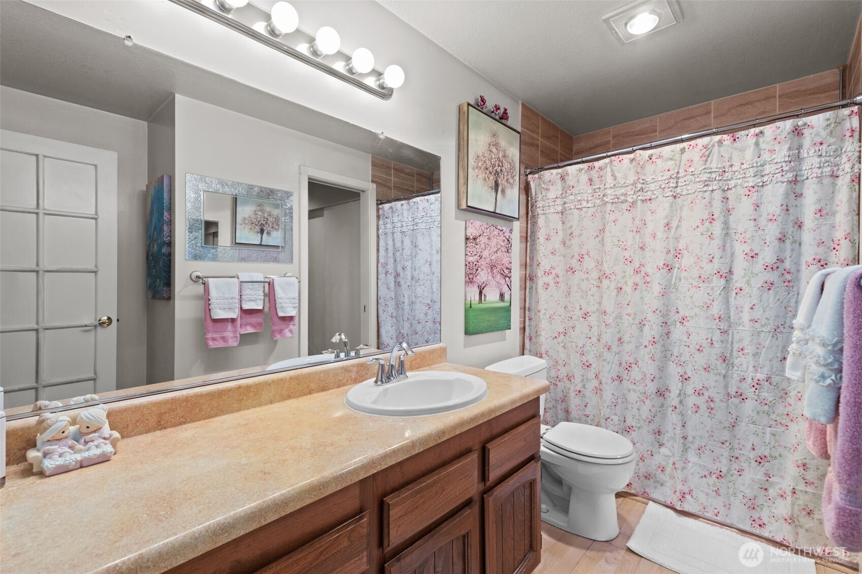 2517 Northeast 4th Street, Unit 523 Renton, WA 98056 - Photo 26 of 32 a bathroom with a granite countertop sink a toilet and a mirror