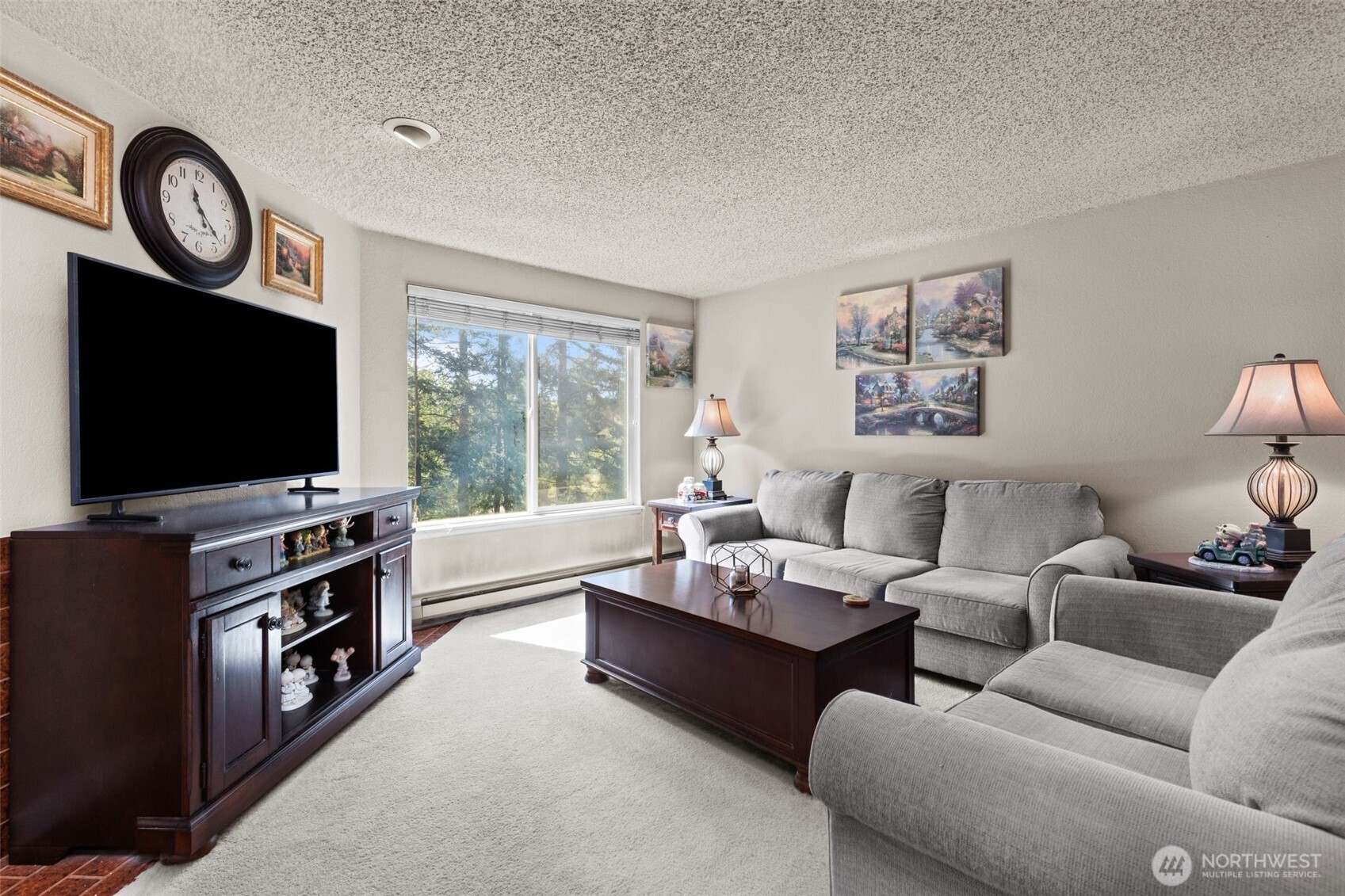 2517 Northeast 4th Street, Unit 523 Renton, WA 98056 - Photo 3 of 32 a living room with furniture and a flat screen tv