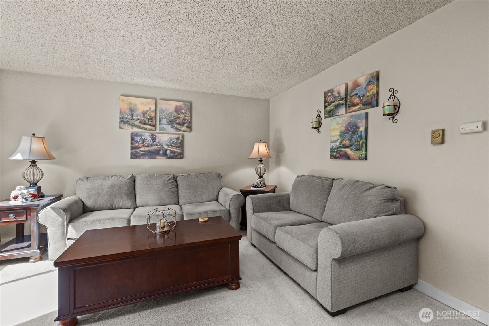 2517 Northeast 4th Street, Unit 523 Renton, WA 98056 - Photo 4 of 32 a living room with furniture and a wall painting