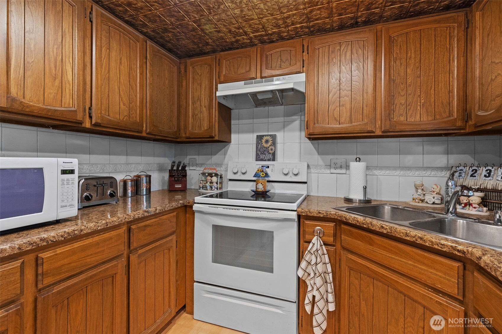 2517 Northeast 4th Street, Unit 523 Renton, WA 98056 - Photo 10 of 32 a kitchen with stainless steel appliances granite countertop wooden cabinets a sink and dishwasher
