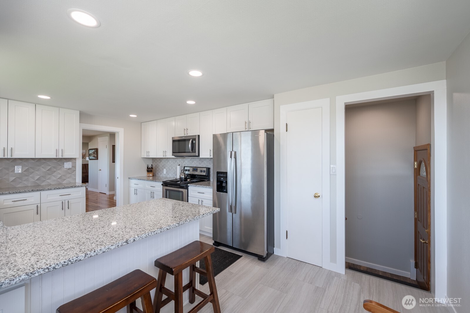 303 Patrick Road Ephrata, WA 98823 - Photo 14 of 38 a kitchen with granite countertop a refrigerator and a sink