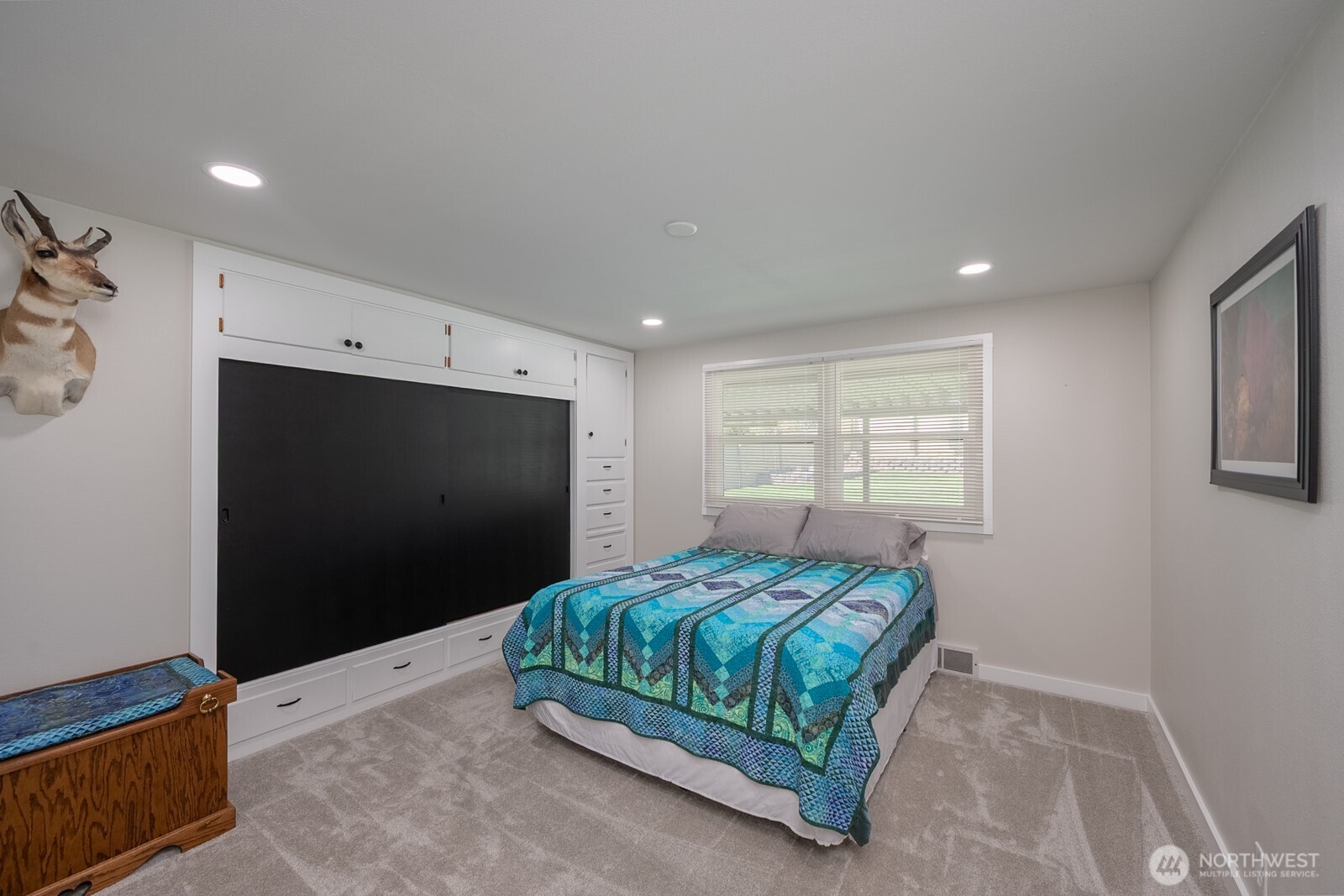 303 Patrick Road Ephrata, WA 98823 - Photo 18 of 38 a bedroom with a bed and a flat screen tv