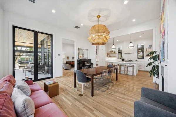 a living room with furniture a chandelier and a large window