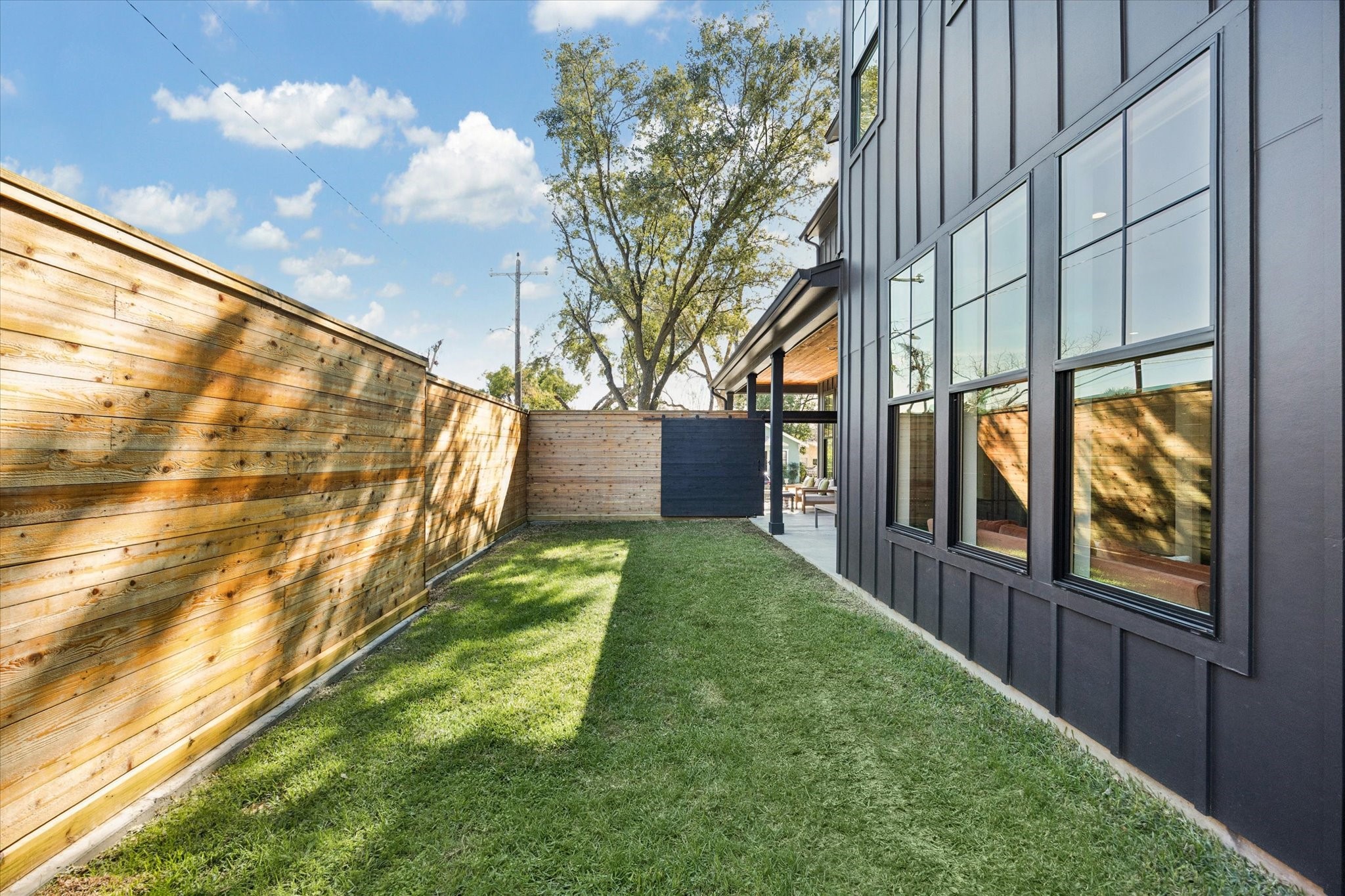 701 Ridge Street Houston, TX 77009 - Photo 16 of 50 Wood privacy fence encloses green space, ideal for pets, play, or relaxed outdoor living.