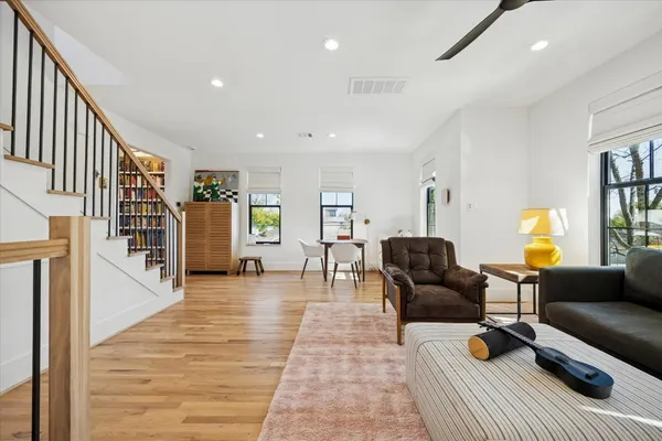 a living room with furniture and a wooden floor