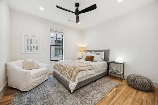 a bedroom with a bed and a couch