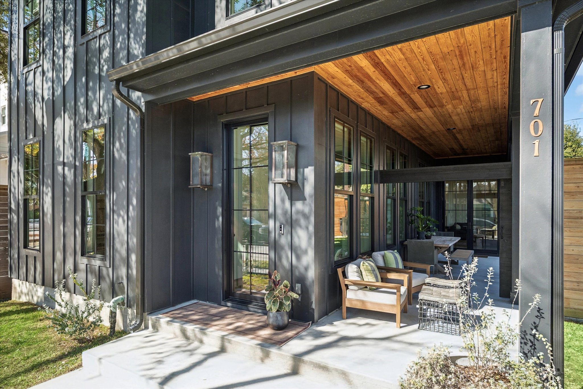 701 Ridge Street Houston, TX 77009 - Photo 3 of 50 Gas lanterns flank the steel entry door. The front porch sitting area connects to the side yard, with the option to close the gate for added privacy.