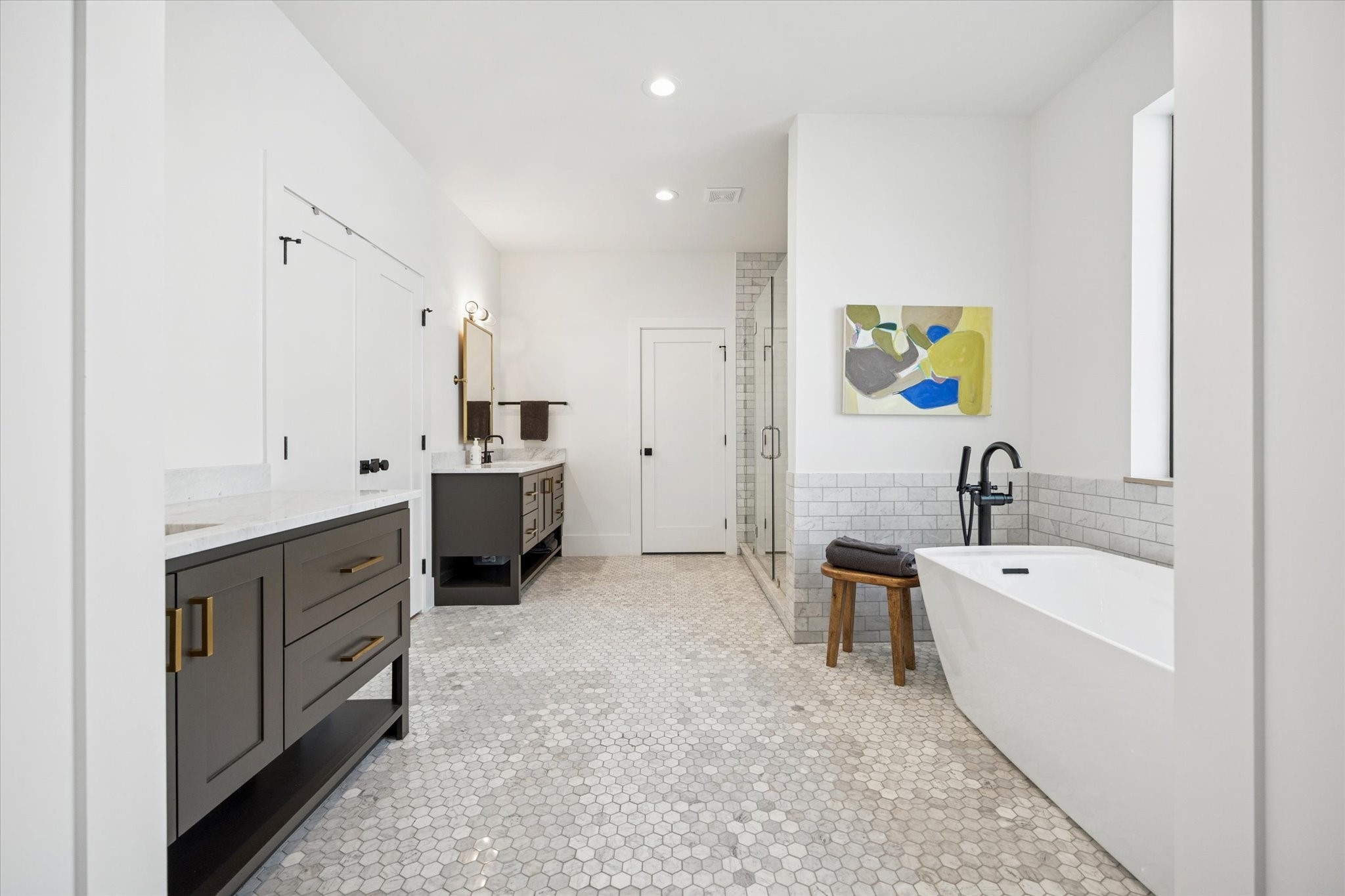 701 Ridge Street Houston, TX 77009 - Photo 33 of 50 Primary bath features dual vanities, soaking tub, glass-enclosed shower, and French door access to the custom closet.