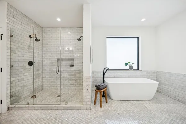 a bathroom with a bathtub and shower