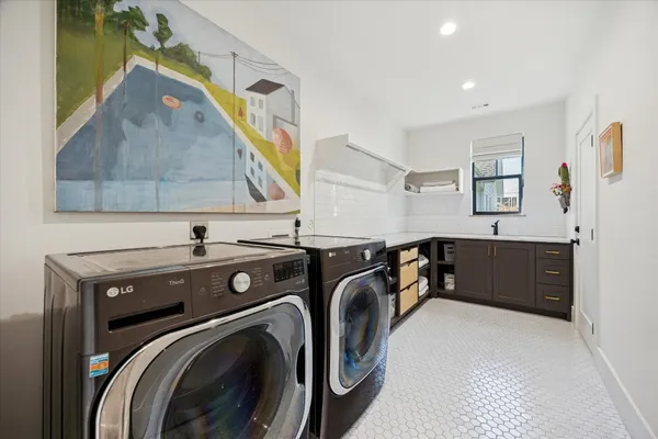 a view of a sink and a washer and dryer