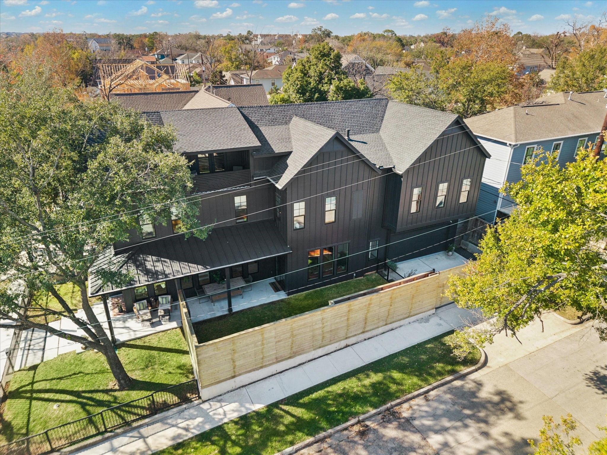 701 Ridge Street Houston, TX 77009 - Photo 49 of 50 Aerial view highlights the striking modern farmhouse design, corner lot positioning, and warm wood privacy fencing.