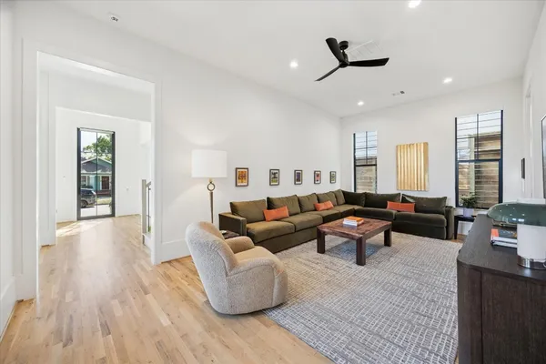 a living room with furniture and a wooden floor
