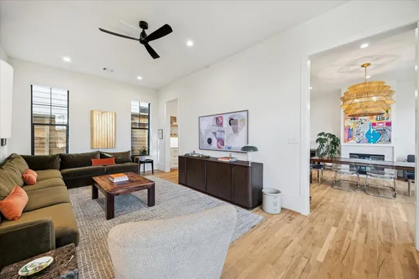 a living room with furniture and wooden floor