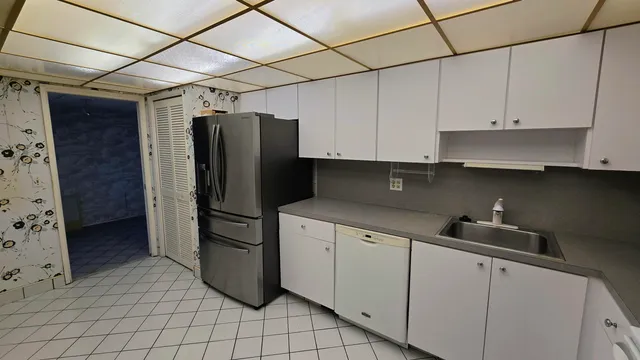 a kitchen with a refrigerator and cabinets