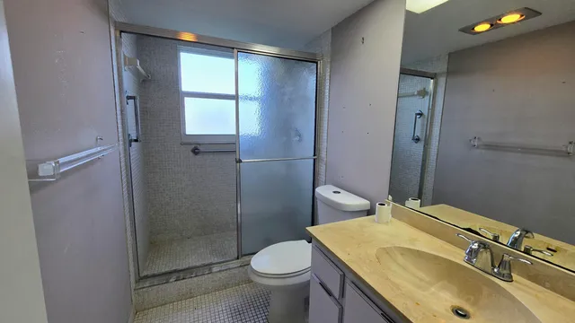 a bathroom with a sink toilet and shower