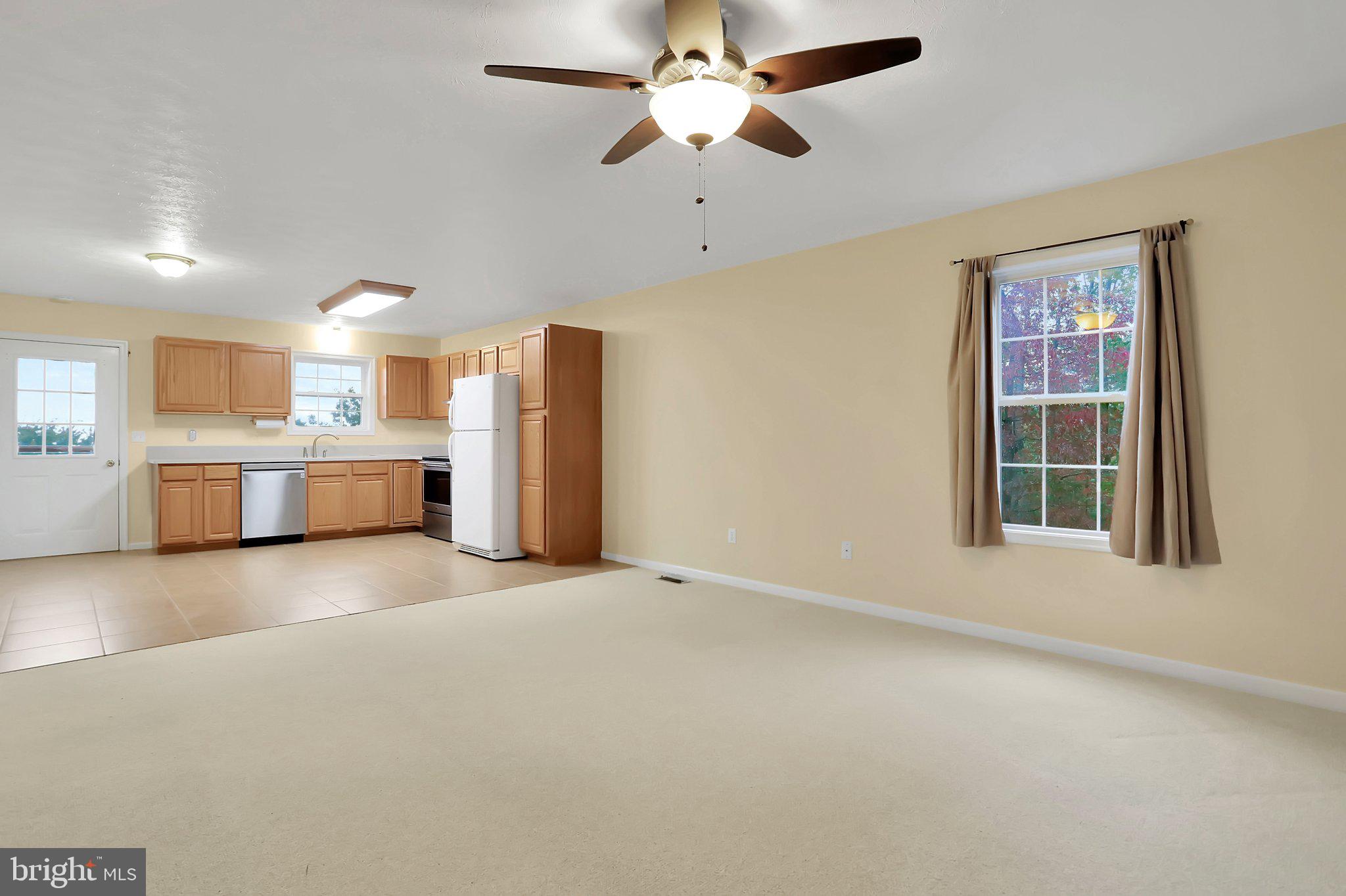 1050 Lower Valley Road Strasburg, VA 22657 - Photo 2 of 34 a view of a kitchen with a stove cabinets a ceiling fan and wooden floor
