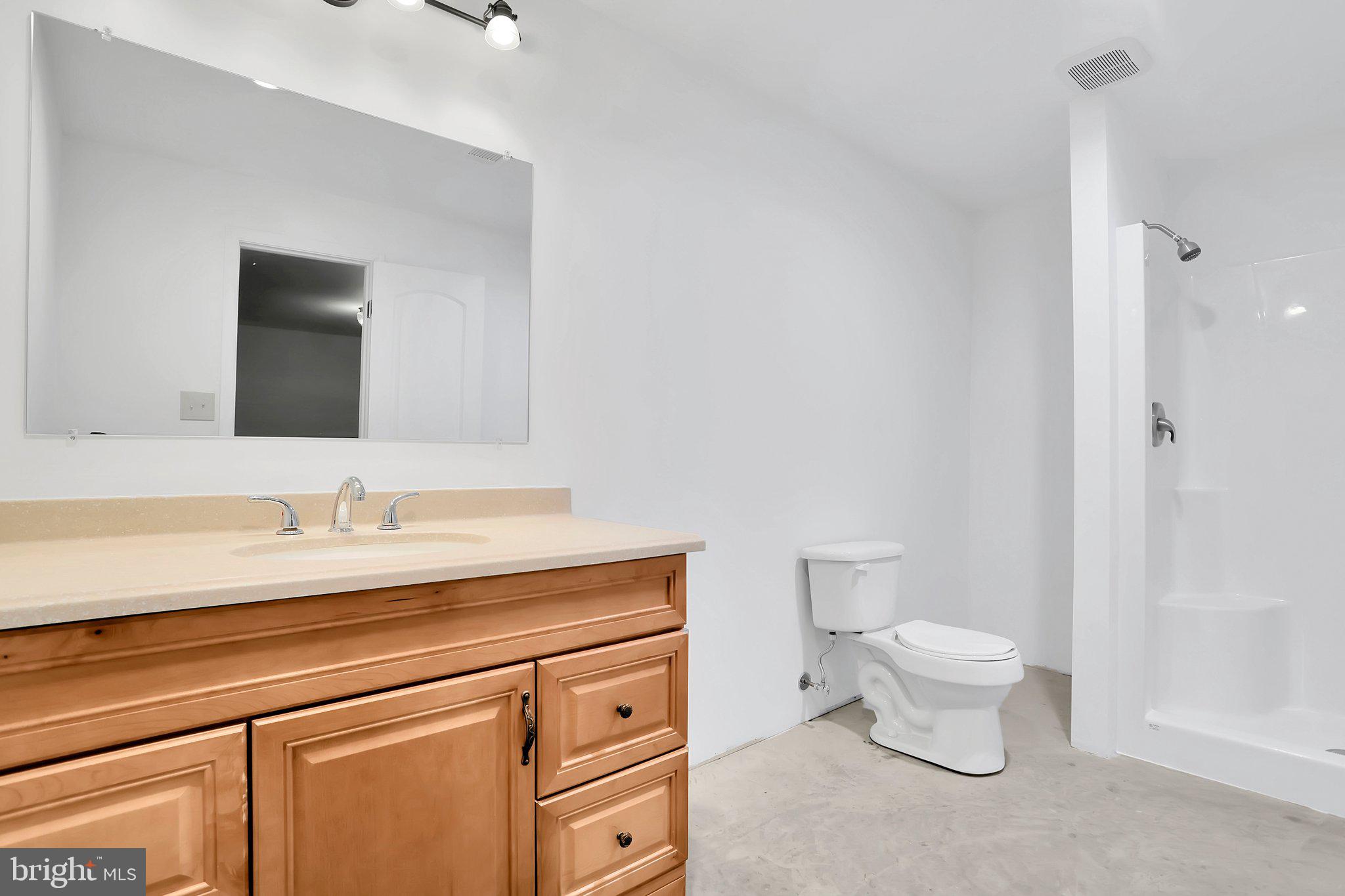 1050 Lower Valley Road Strasburg, VA 22657 - Photo 25 of 34 a bathroom with a granite countertop toilet sink and mirror