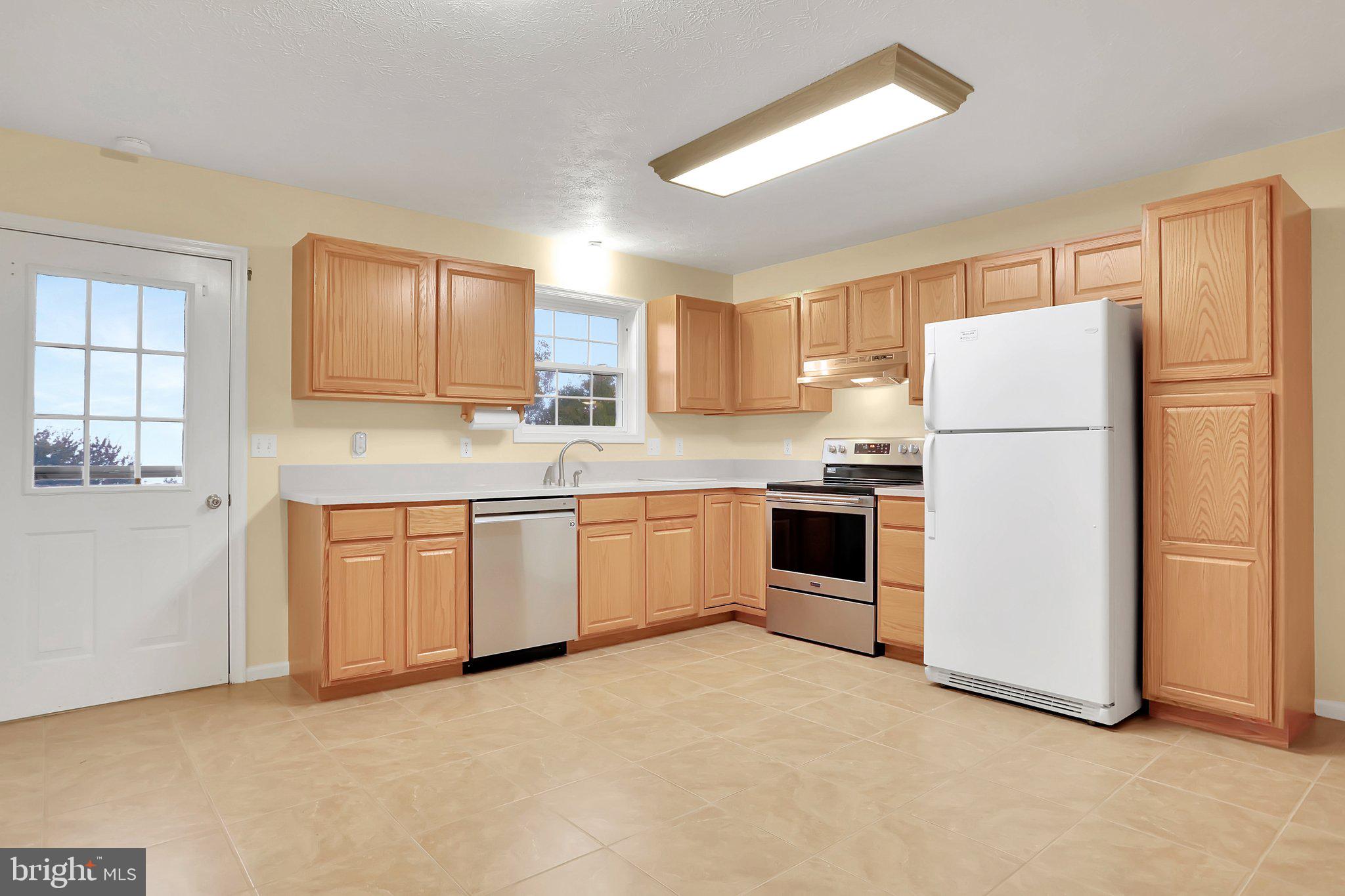 1050 Lower Valley Road Strasburg, VA 22657 - Photo 5 of 34 a kitchen with a refrigerator sink and cabinets