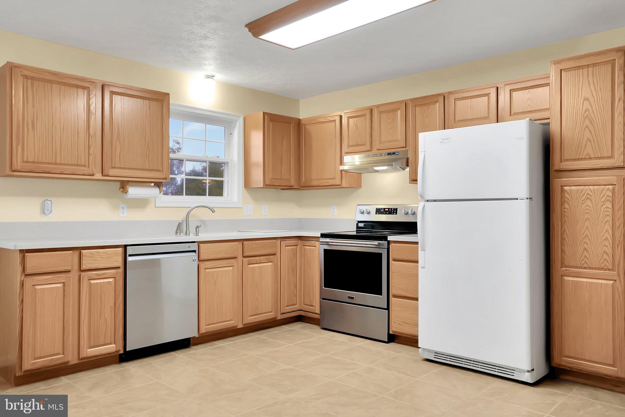 1050 Lower Valley Road Strasburg, VA 22657 - Photo 6 of 34 a white kitchen with granite countertop a refrigerator stove top oven and sink