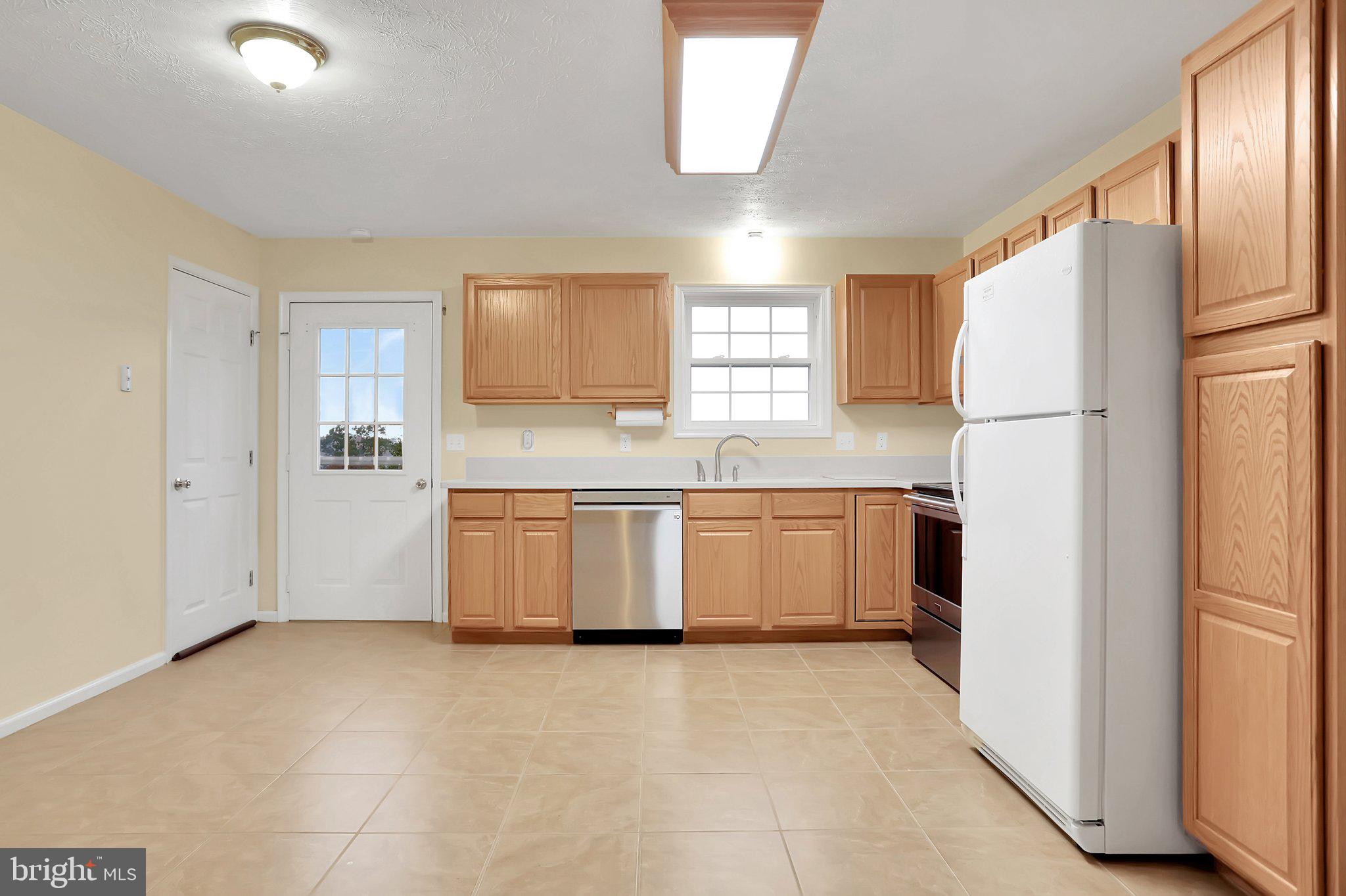 1050 Lower Valley Road Strasburg, VA 22657 - Photo 9 of 34 a kitchen with a refrigerator a sink and a window