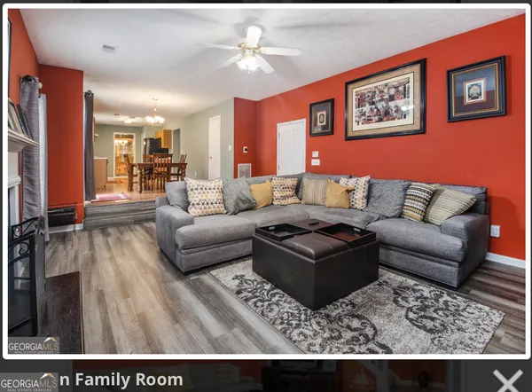 a living room with furniture and a rug