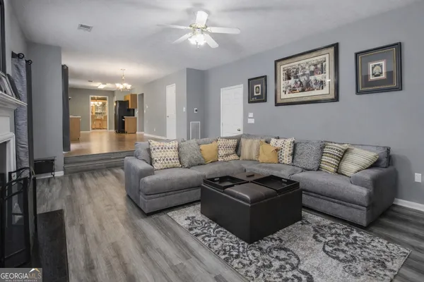 a living room with furniture and a rug