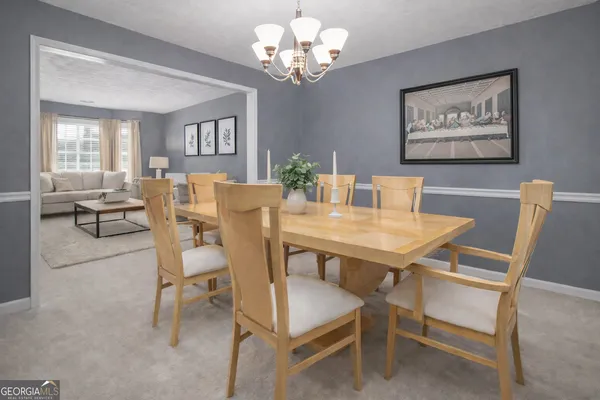 a view of a dining room with furniture and chandelier