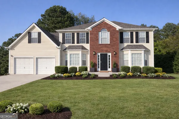 a front view of a house with a yard