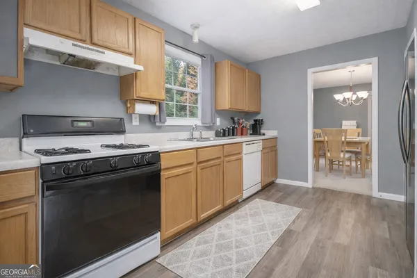 a kitchen with a stove a sink and a microwave