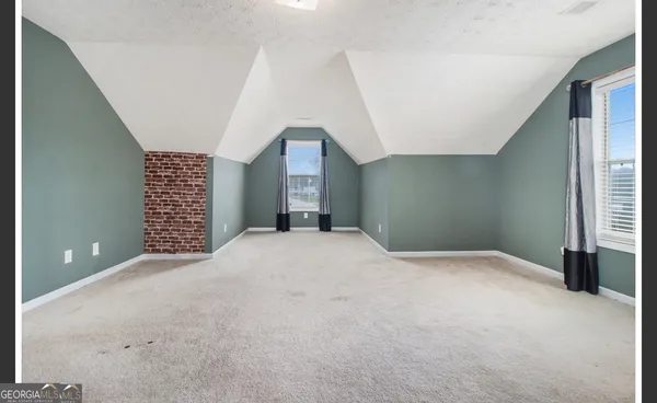 a view of empty room with a fireplace