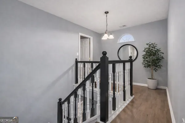a view of entryway and hall with a chandelier