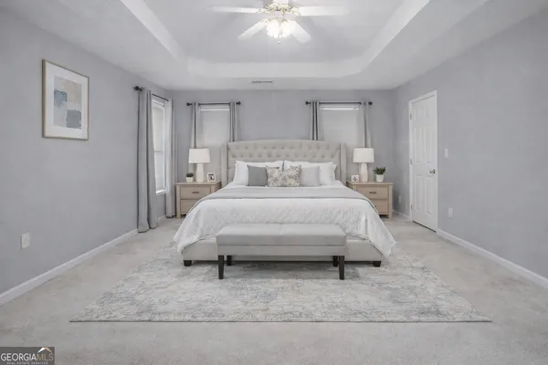a bedroom with a bed and a ceiling fan