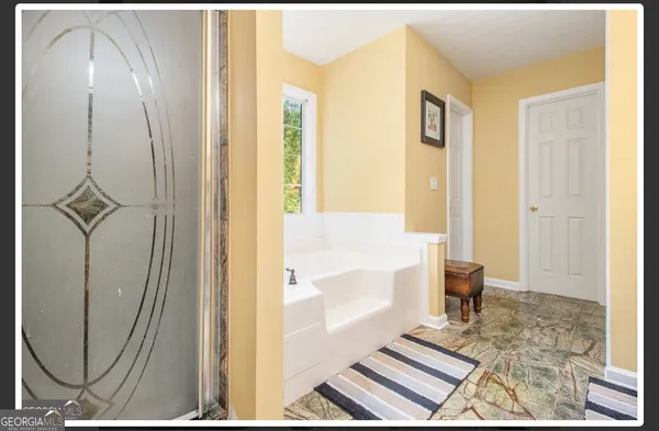 a bathroom with a bathtub and a shower