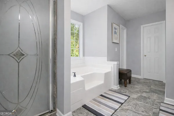 a bathroom with a bathtub and a shower