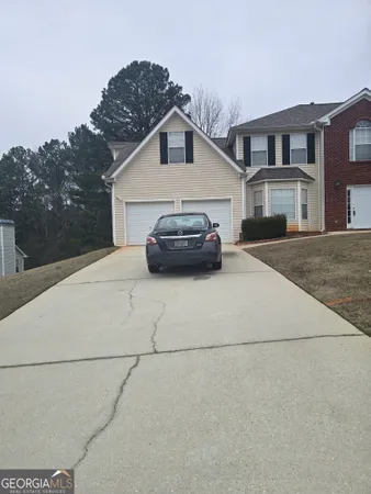 a car parked in front of white house