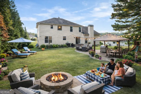 a view of a patio with furniture and a garden