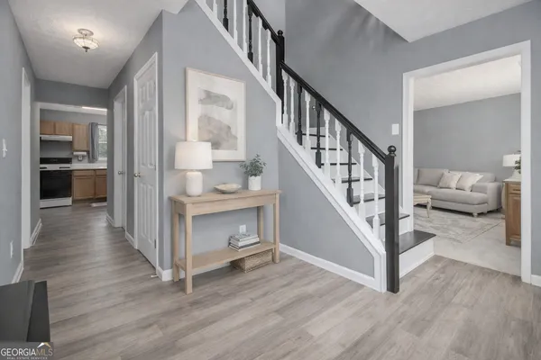 a view of entryway and hall with wooden floor