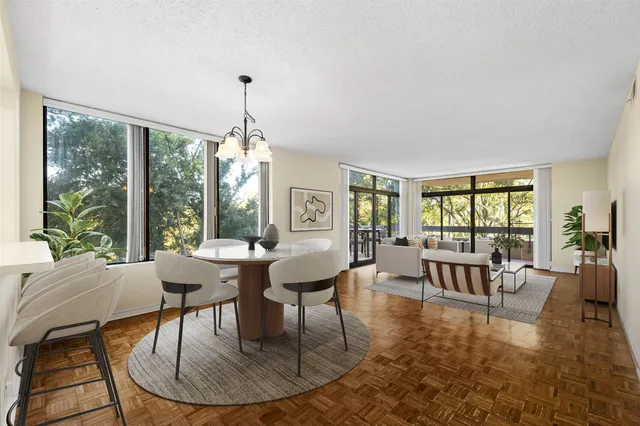 a living room with furniture a large window and a table