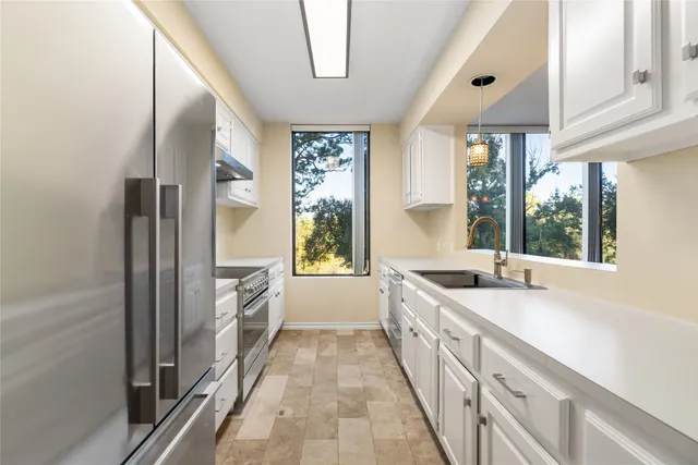 a large kitchen with a sink and windows