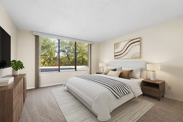 a bedroom with a large bed and a large window