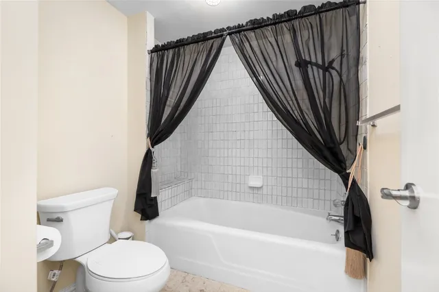 a bathroom with a bathtub and a toilet