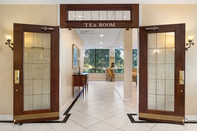 a living room with furniture a flat screen tv and a large window