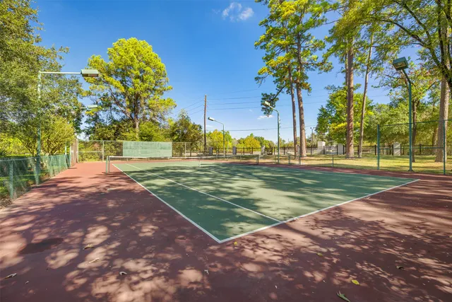 a view of a swimming pool with lawn chairs under an umbrella