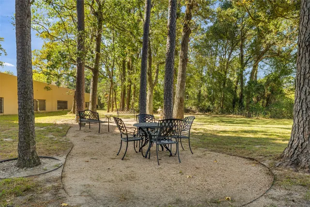 a view of a yard with wooden fence