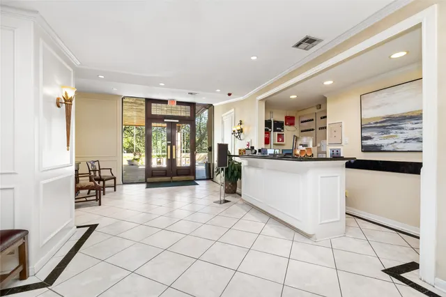 a kitchen with stainless steel appliances kitchen island granite countertop a refrigerator a sink and white cabinets