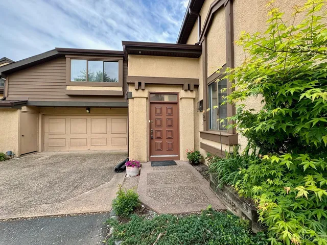 a front view of a house with garage